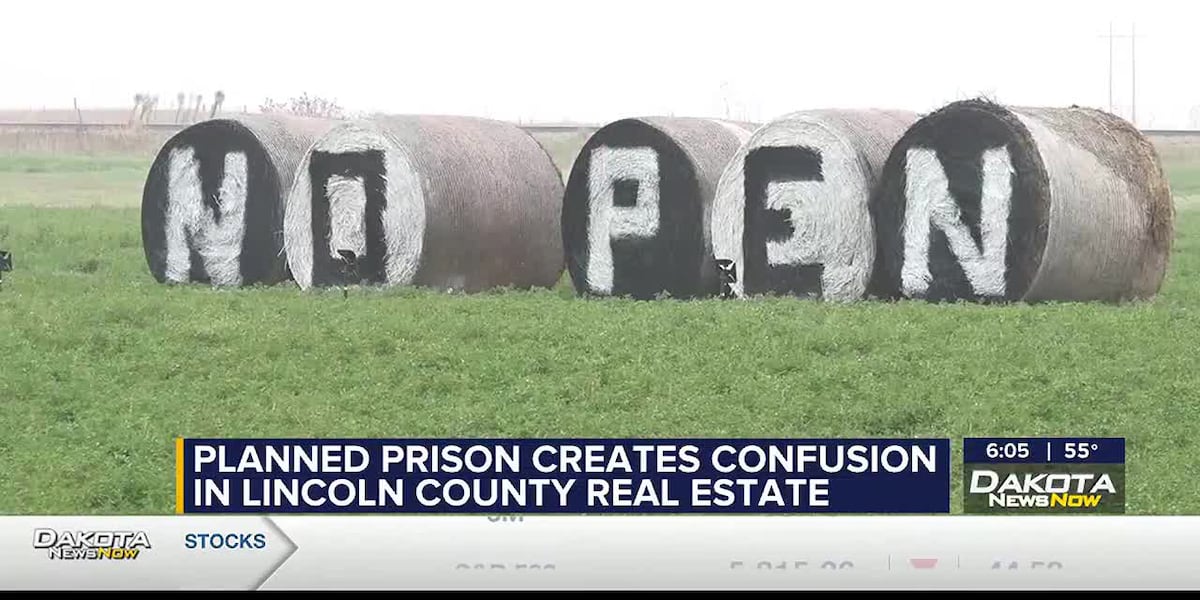 Concerned local resident stands in front of a neighborhood house near prison facility.