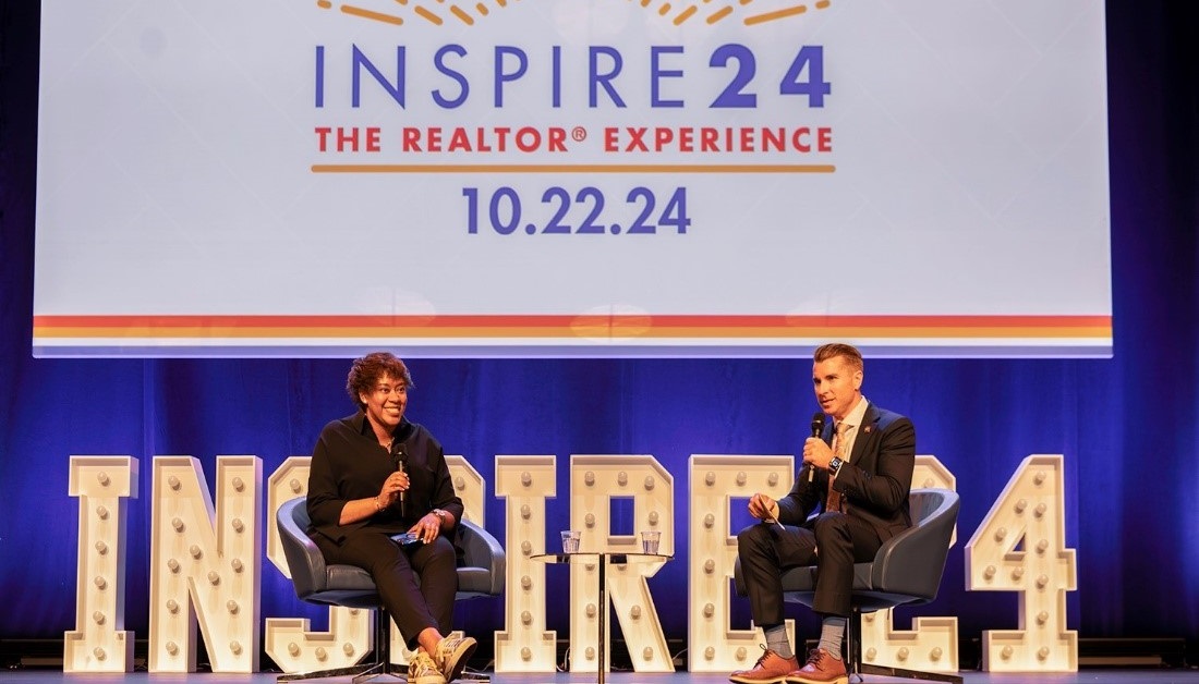 NAR leader speaking at podium with American flag background in Washington D.C.