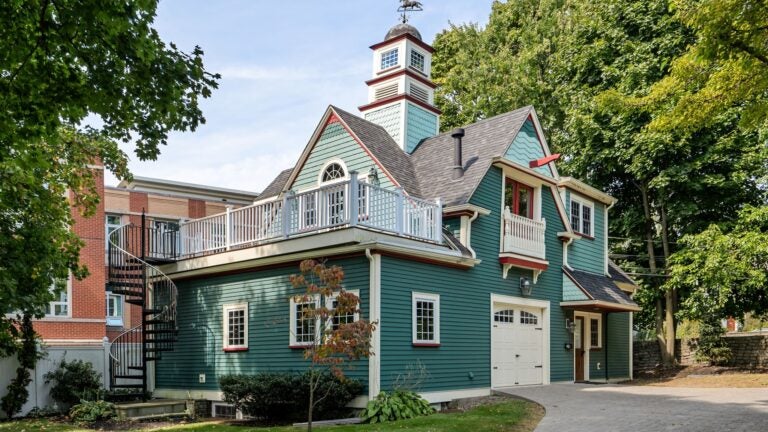 Dorchester historic carriage house for sale with stone fireplace features.