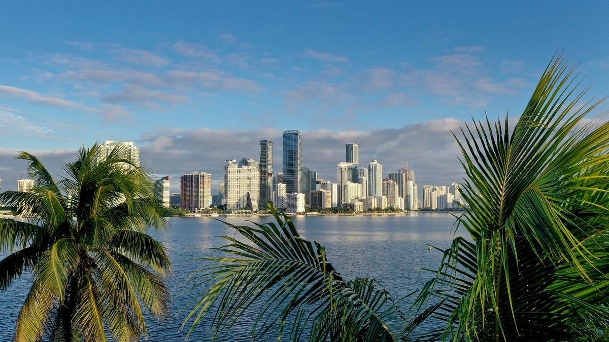 Miami skyline with rising prices indicator, amidst global economic uncertainty.