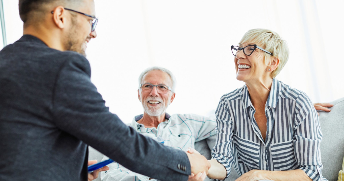 Real estate agents gather around a conference table discussing non-traditional MLS listings.