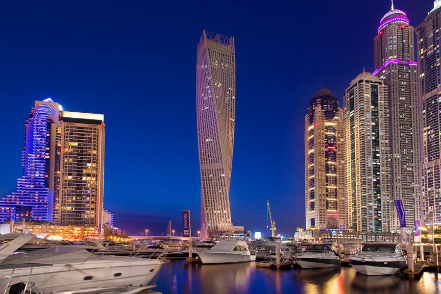 Dubai property investment guide with map of city and real estate buildings.