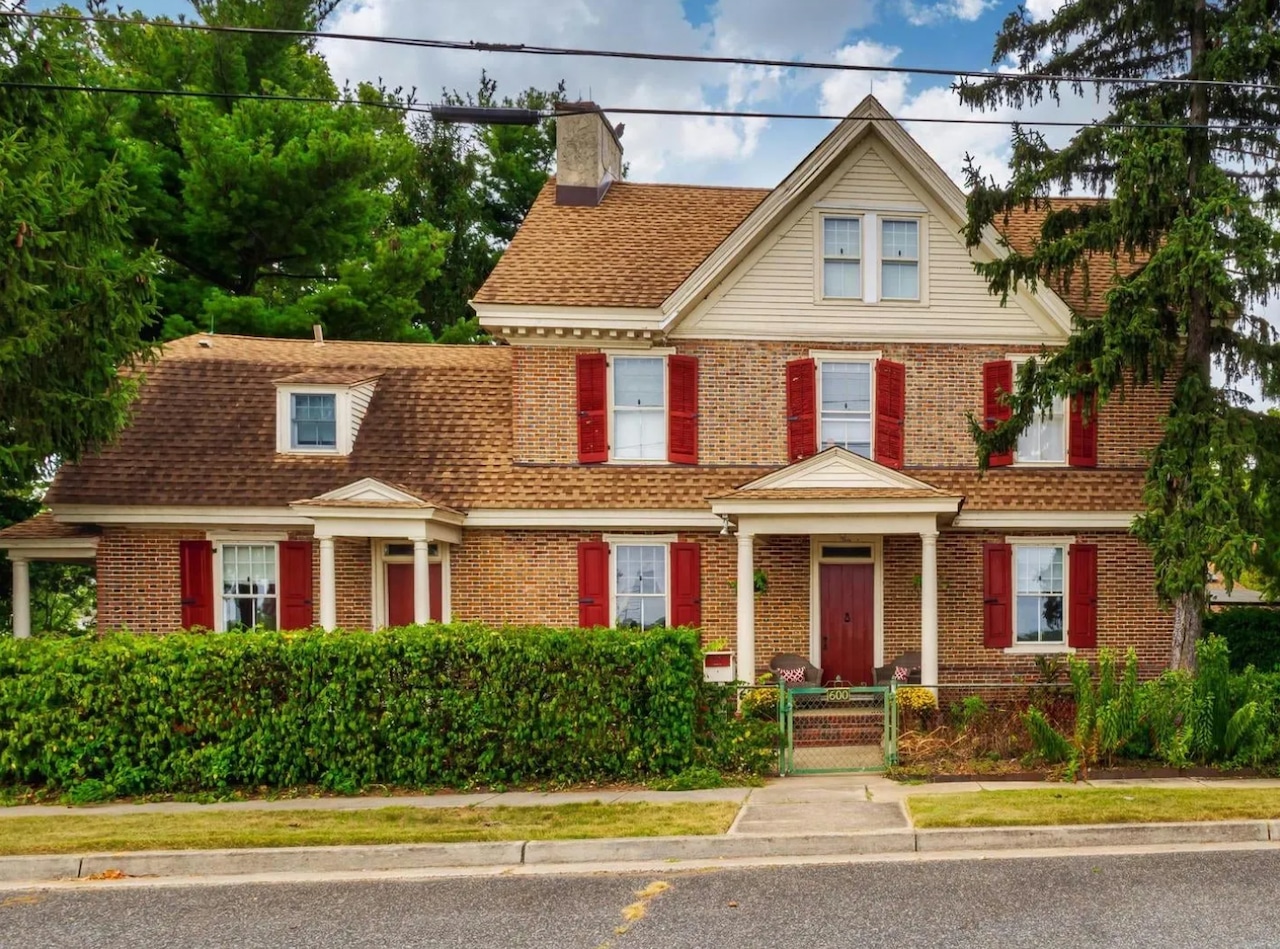 Vintage New Jersey home exterior with charming facade amidst lush neighborhood surroundings.