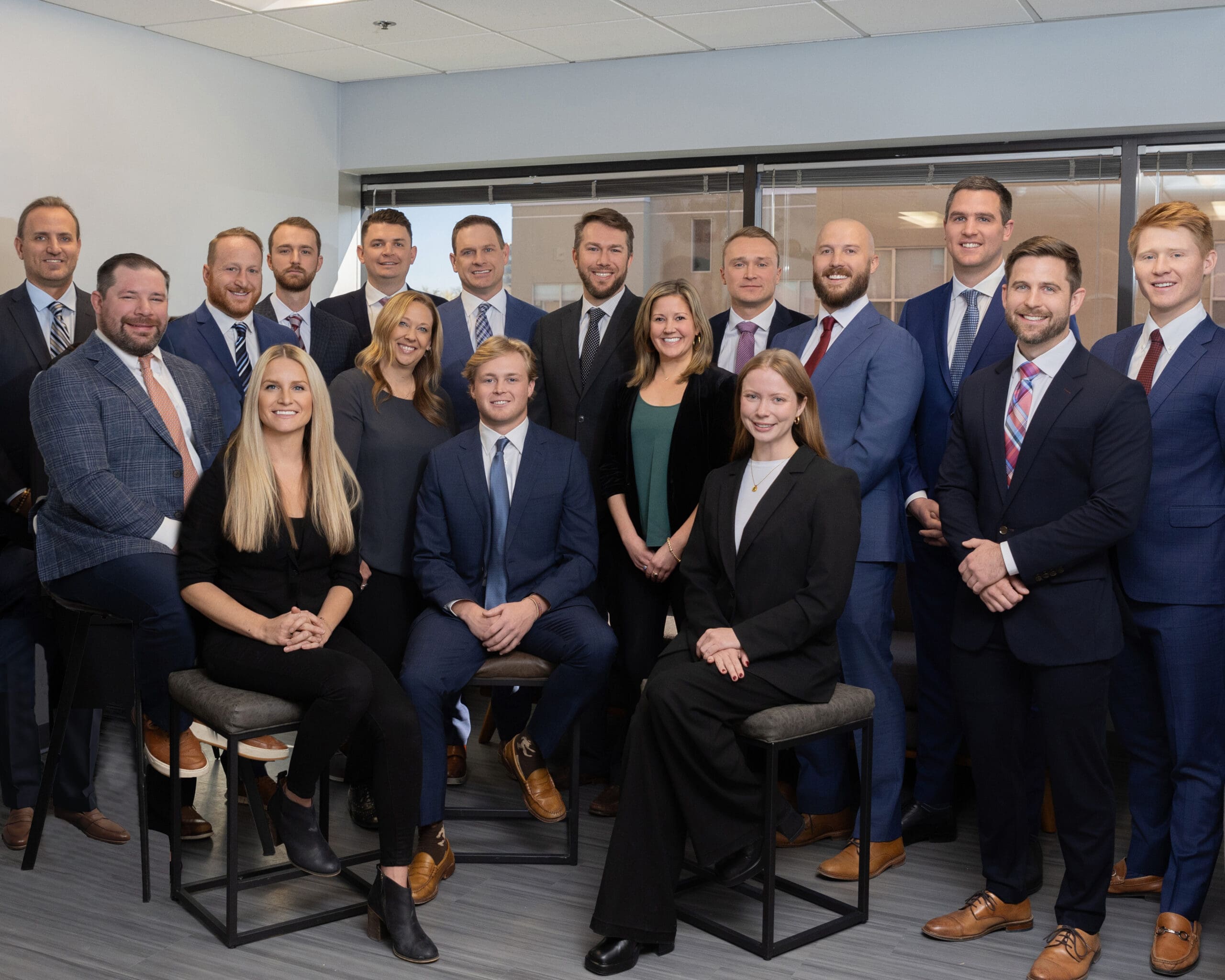 Business professionals shaking hands in Denver office, representing partnership between Capstone Colorado and MMG Advisors.