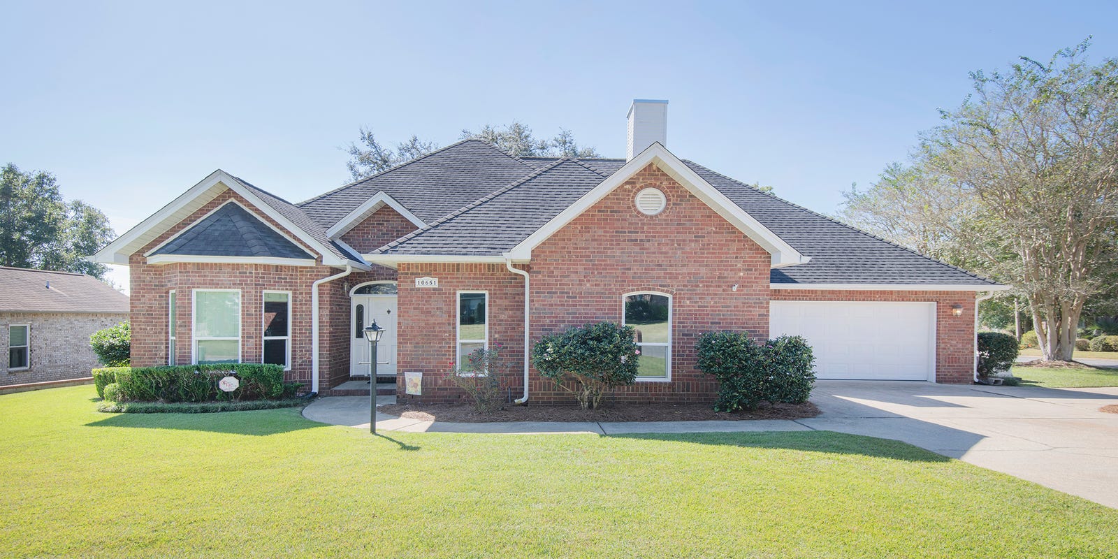 Stunning brick estate with expansive outdoor room in scenic Hills North landscape.