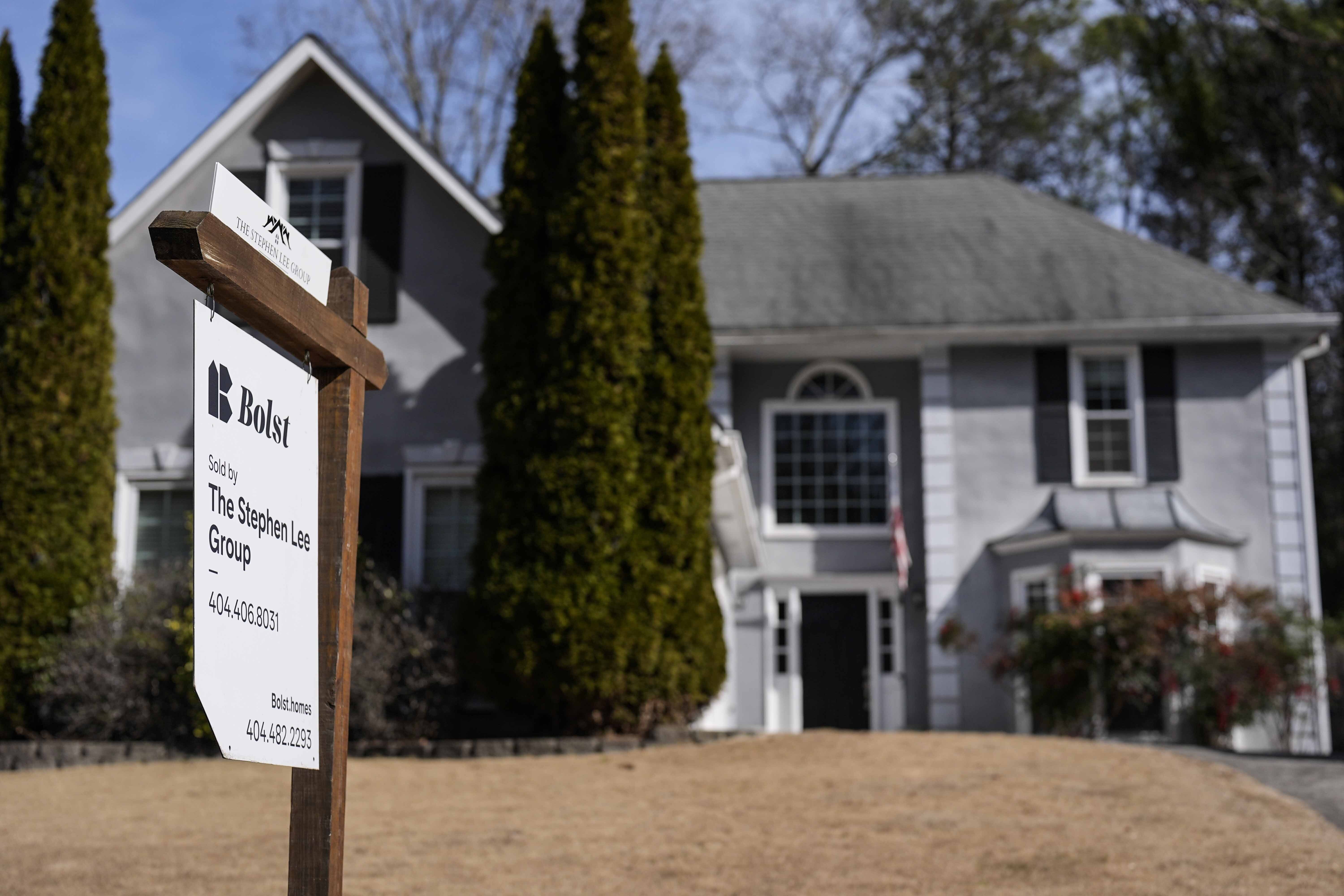 Homebuyers celebrate amidst rising sales in US housing market with lower interest rates.