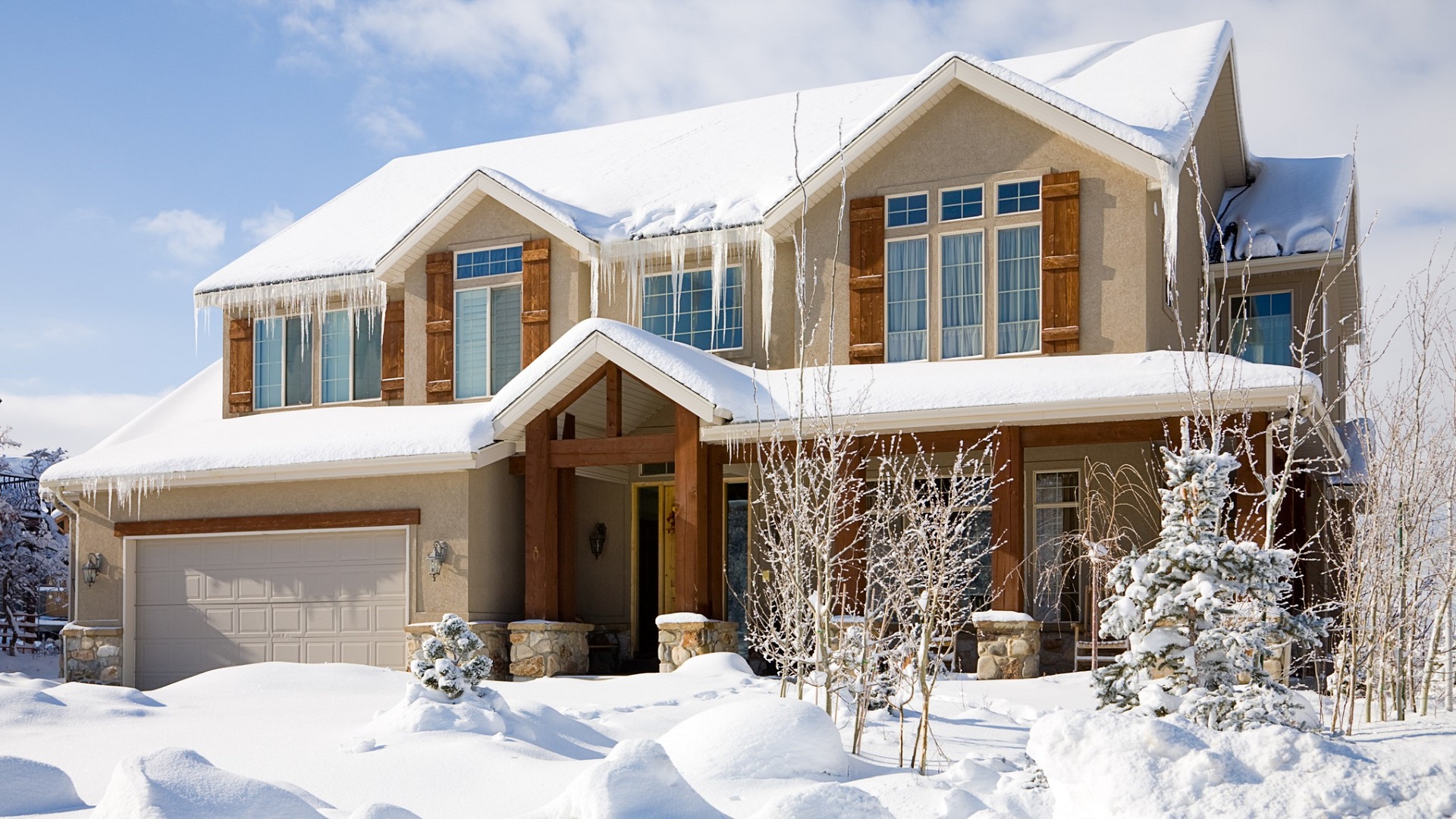 Homeowner prepares house for winter sale with decorations and outdoor signage.