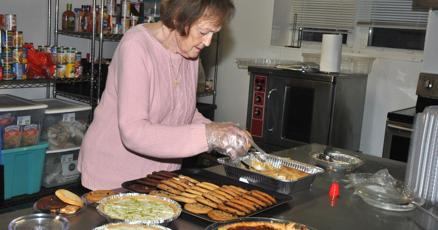 Local real estate company serves Thanksgiving meal to underprivileged community members.