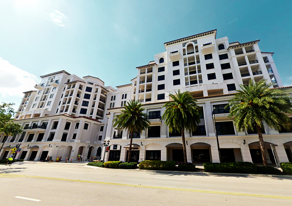 Palm Beach County condo sales leader stands in front of 200 East building.