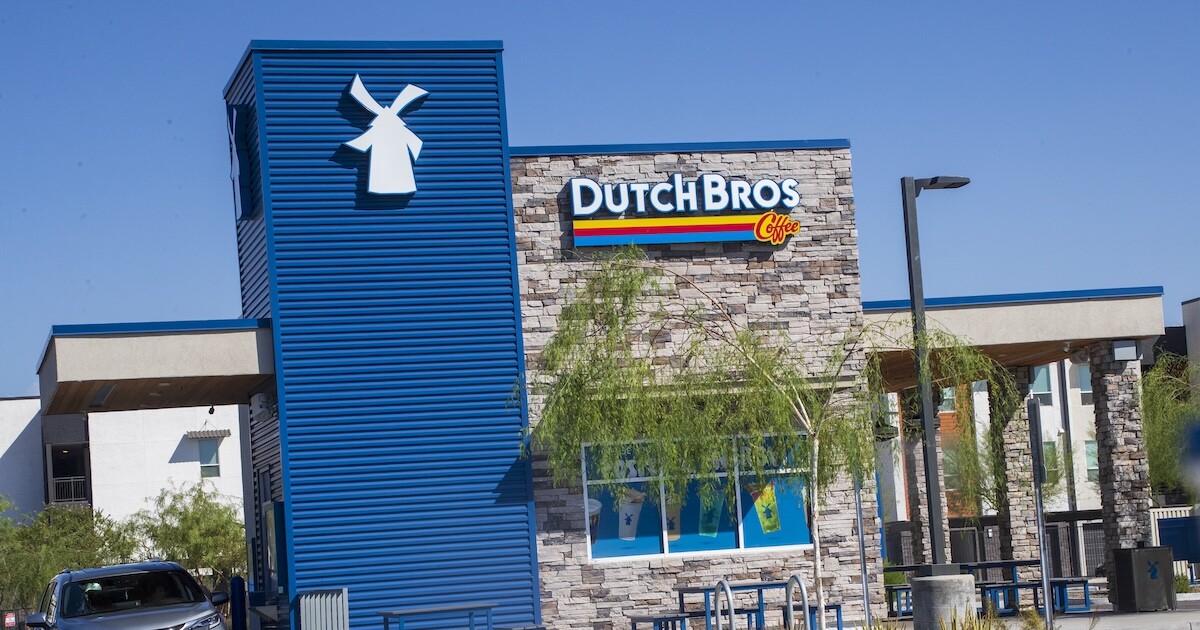 Dutch Bros CEO Joth Ricci stands in front of coffee shop properties.