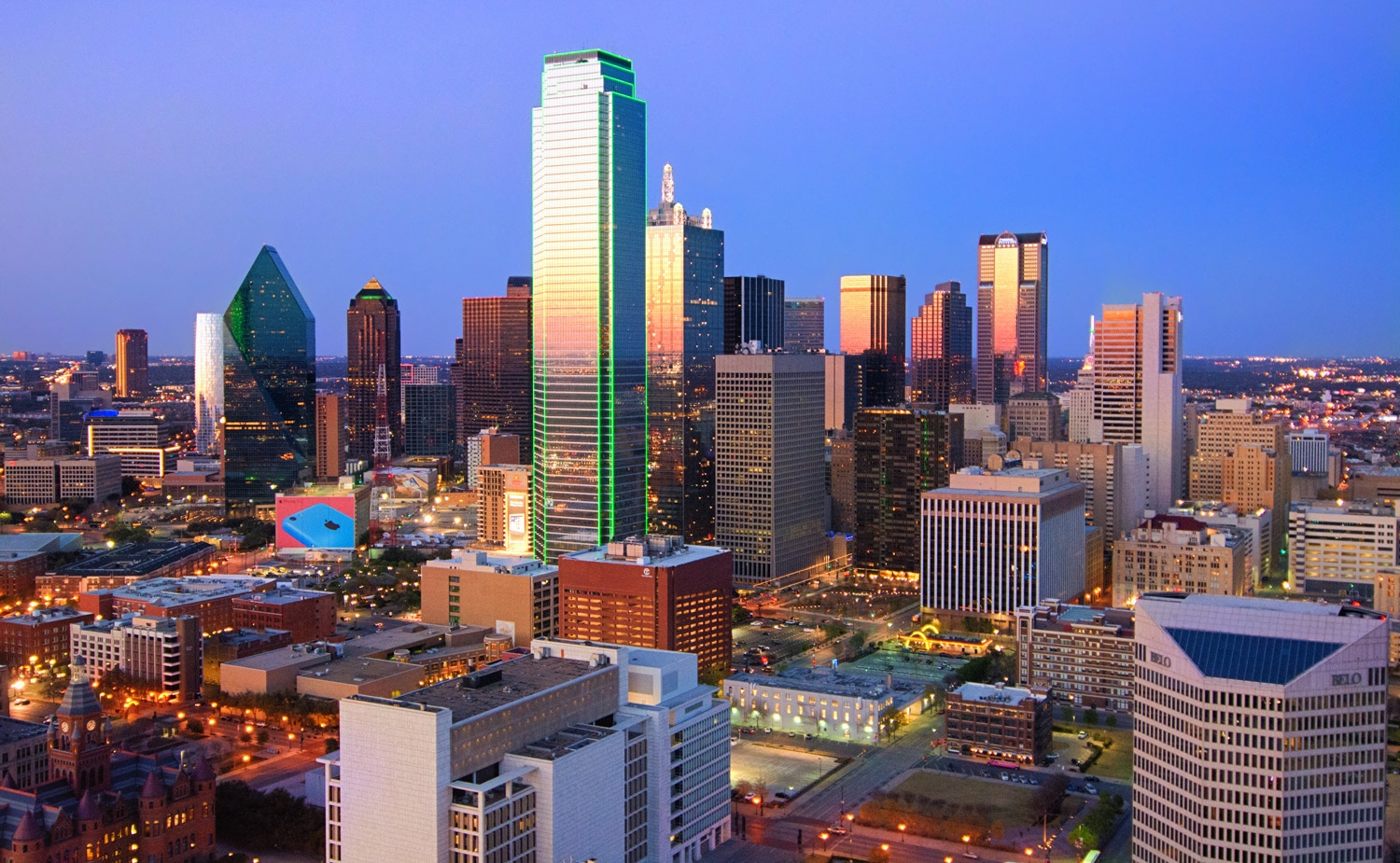 Dallas skyline with bustling streets and skyscrapers, highlighting commercial real estate growth.