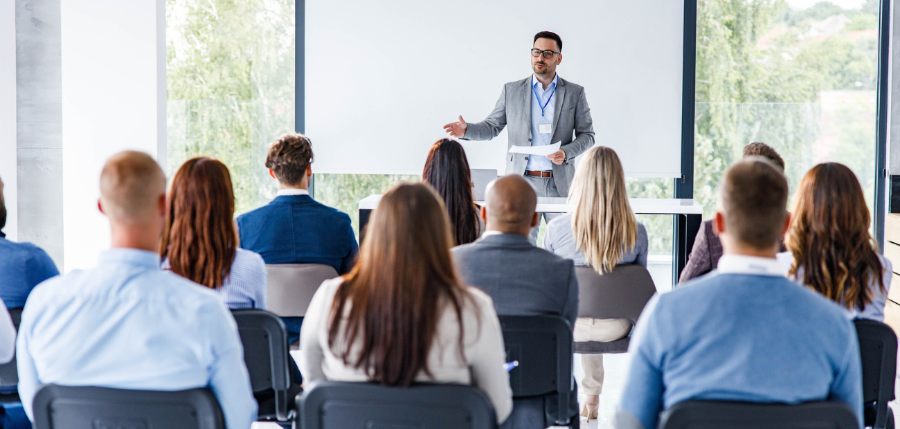 Person giving speech on stage, overcoming stage fright for effective communication.