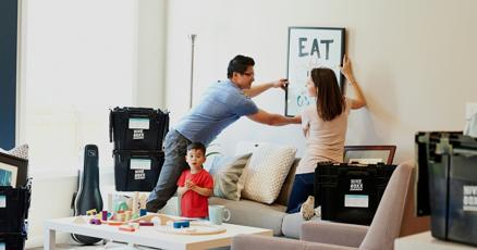 Real estate agent showing house to homeowners, selling properties with professional help.