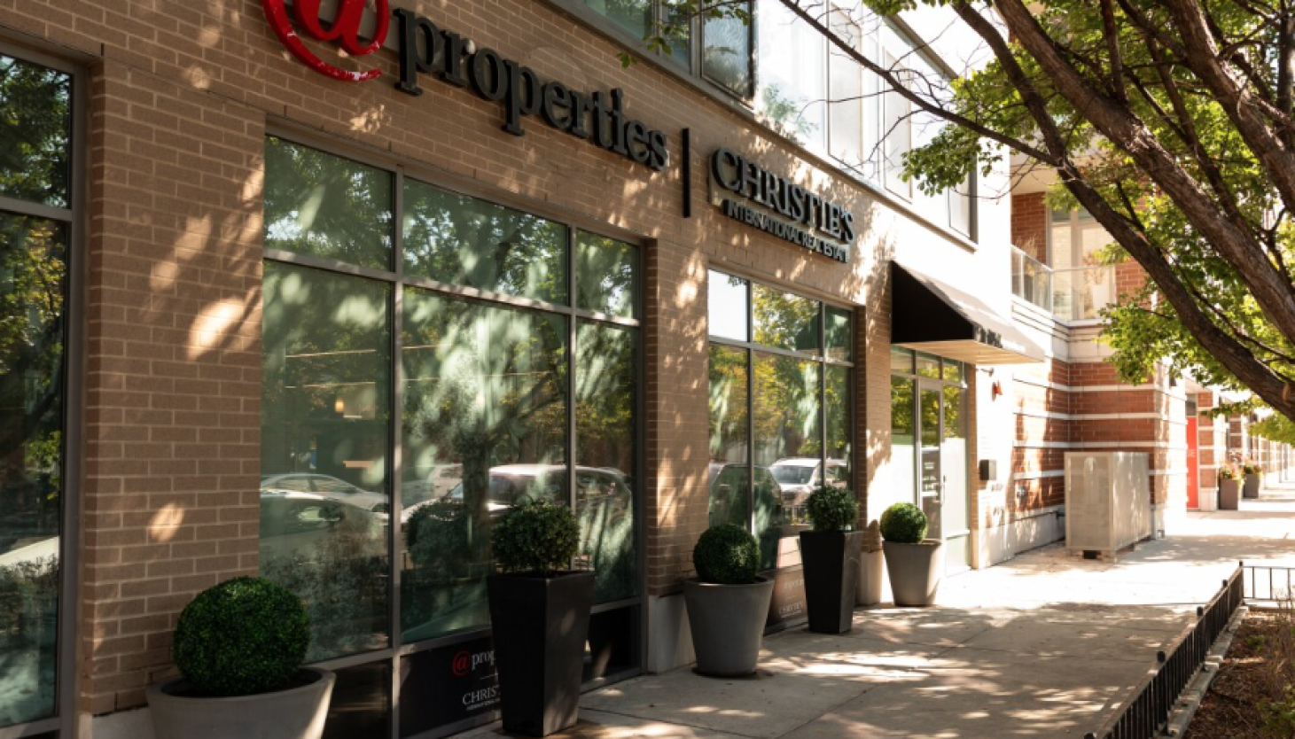 Compass acquires @properties and Christie's for $444M, expanding real estate portfolio.