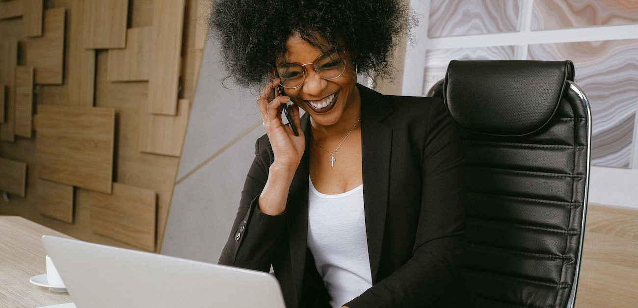 Real estate professionals communicating with clients in a modern office setting.