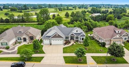 Large family homes in rural western Iowa landscape with rolling hills.