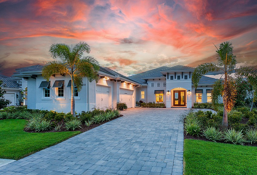 Lakewood Ranch residential sales leaders pose in front of Sarasota County homes.