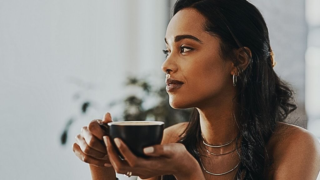 Business professional meditates in office setting, boosting productivity with mindful practice techniques.