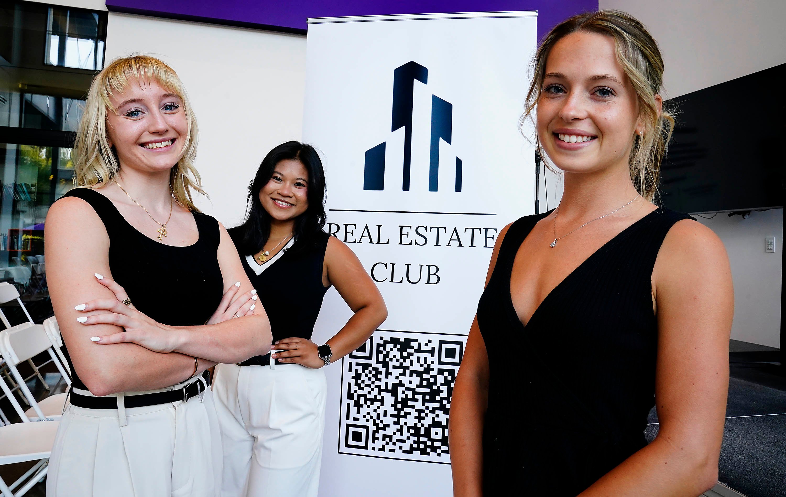 Business student participates in real estate club, exploring global market opportunities.