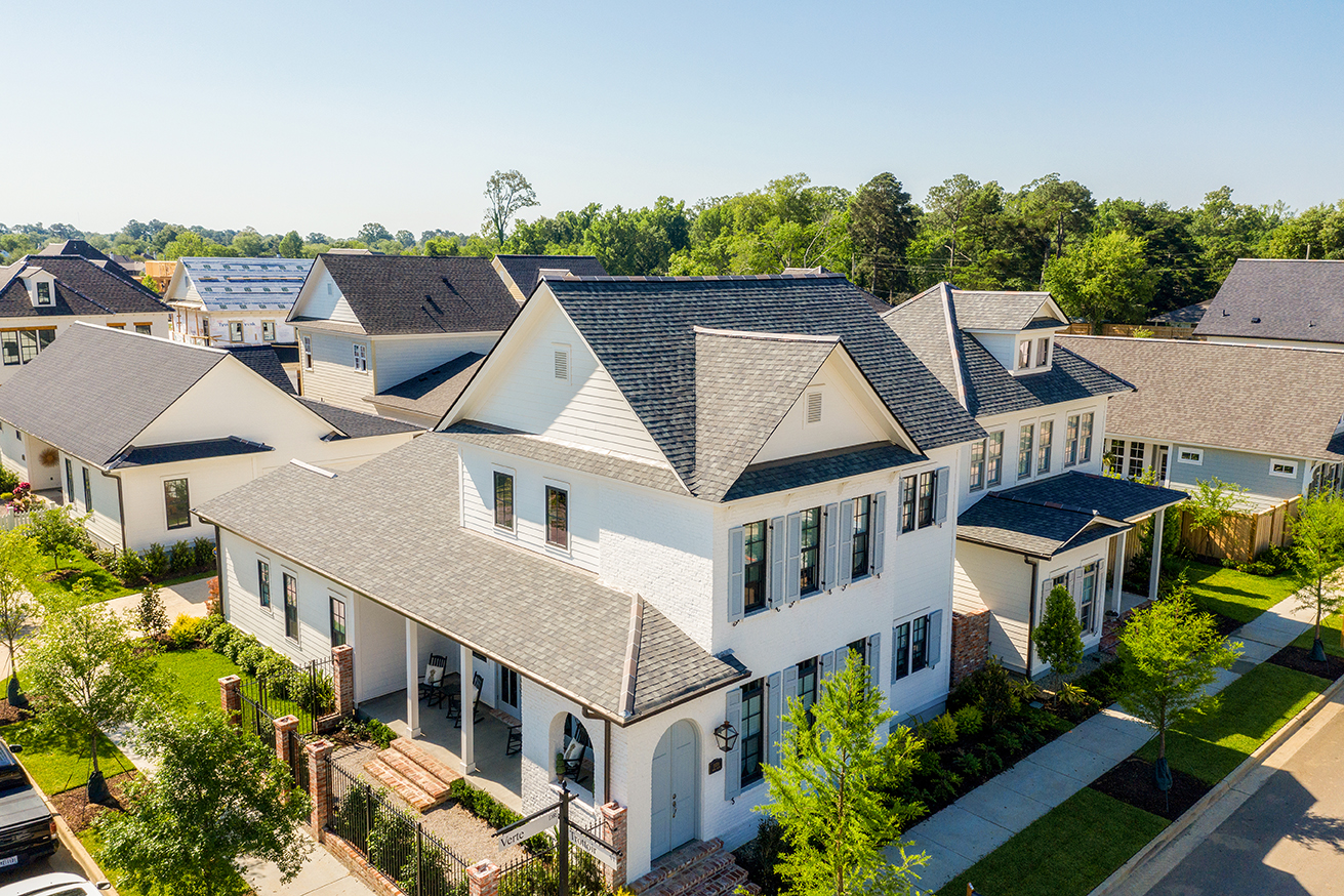 Real estate professionals gather at a conference discussing property market changes nationwide.