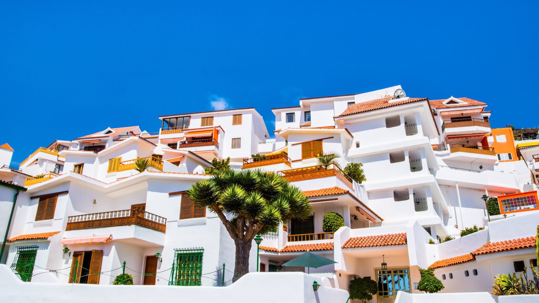 Spanish government officials discuss potential 100% tax on foreign property purchases.