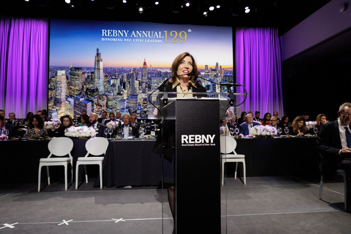 Real estate professionals gather for awards amidst protests outside ceremony location.