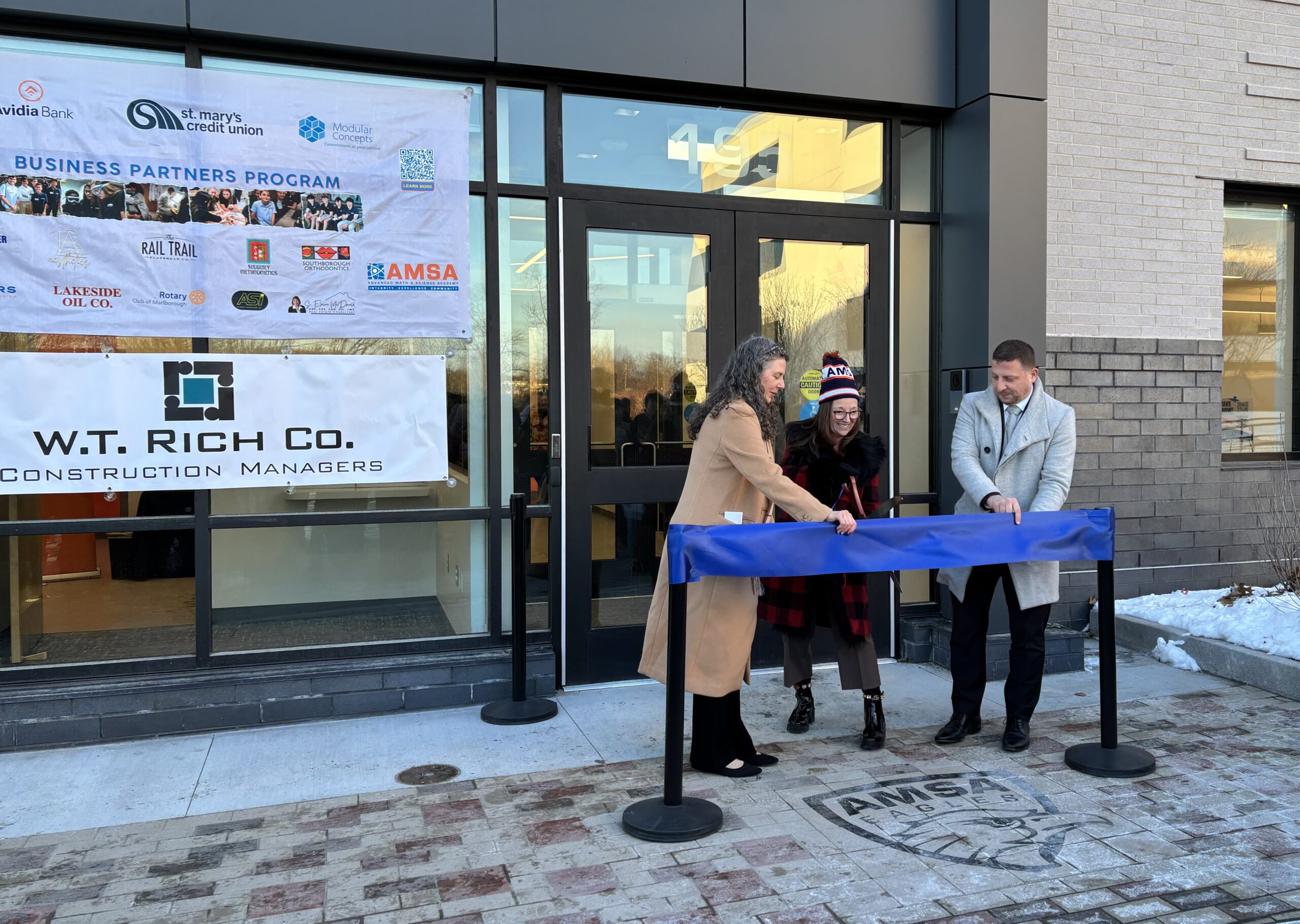 Architects cut ribbon at new Massachusetts charter school STEM facility opening.