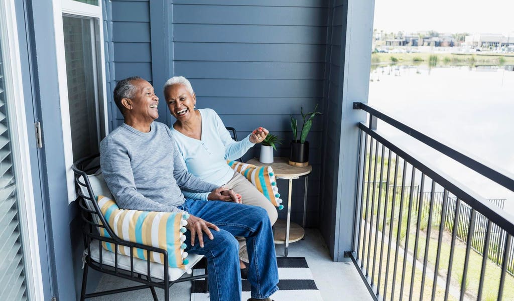 Family members navigating paperwork and emotions during home selling process outdoors.