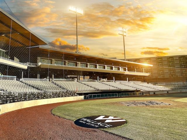 Wallace Realty logo displayed on-field at Knoxville Smokies baseball stadium sponsorship announcement.