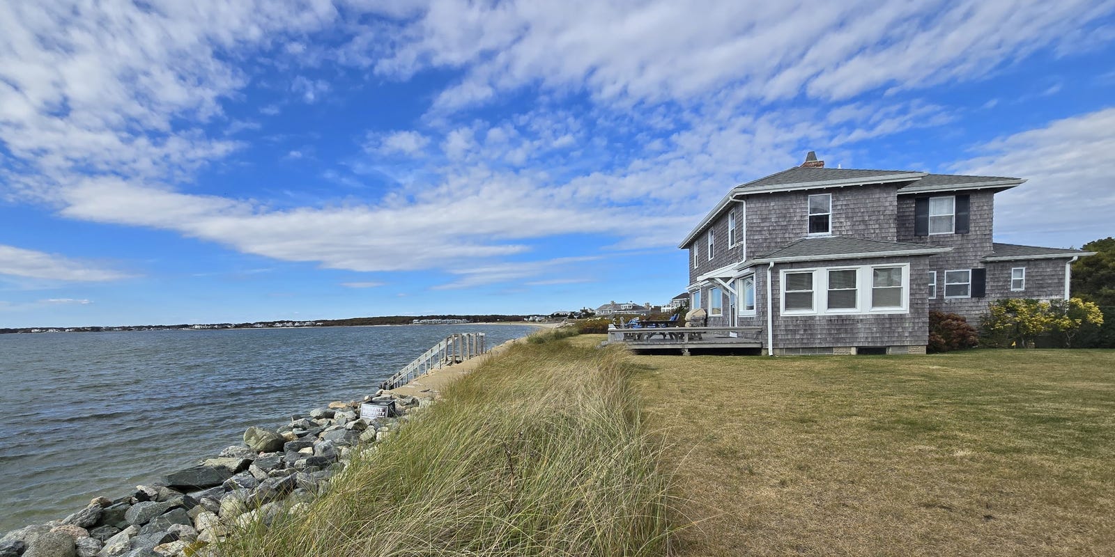 Waterfront property in West Yarmouth, Massachusetts, with scenic harbor views and boats.