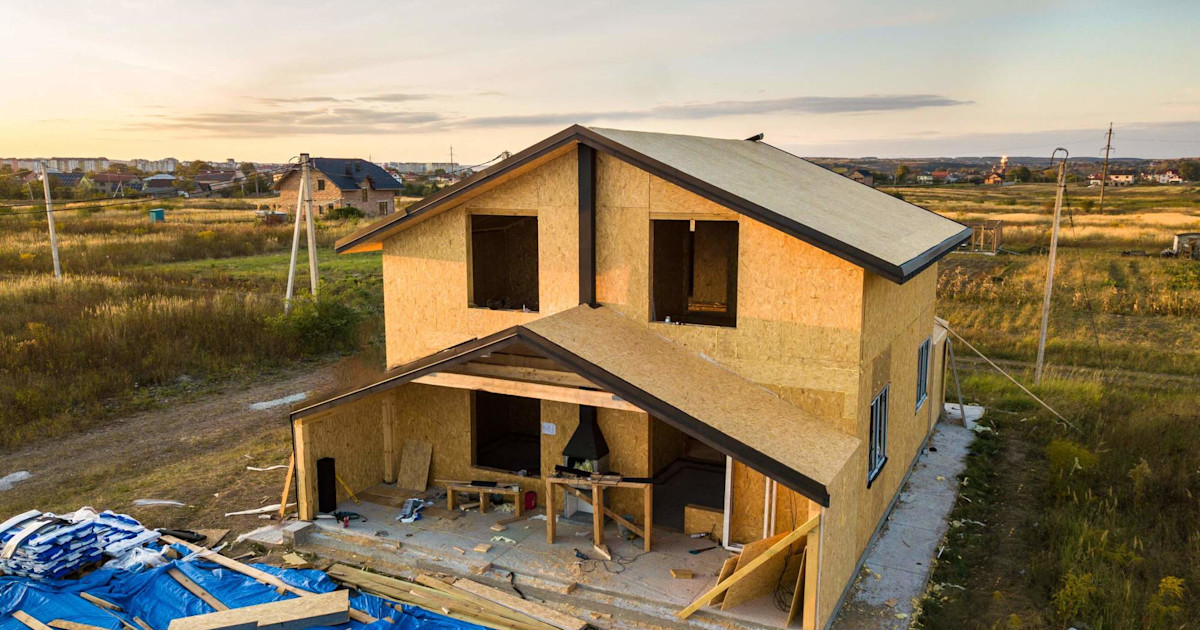 Construction worker halts home building project amidst plummeting builder confidence nationwide.