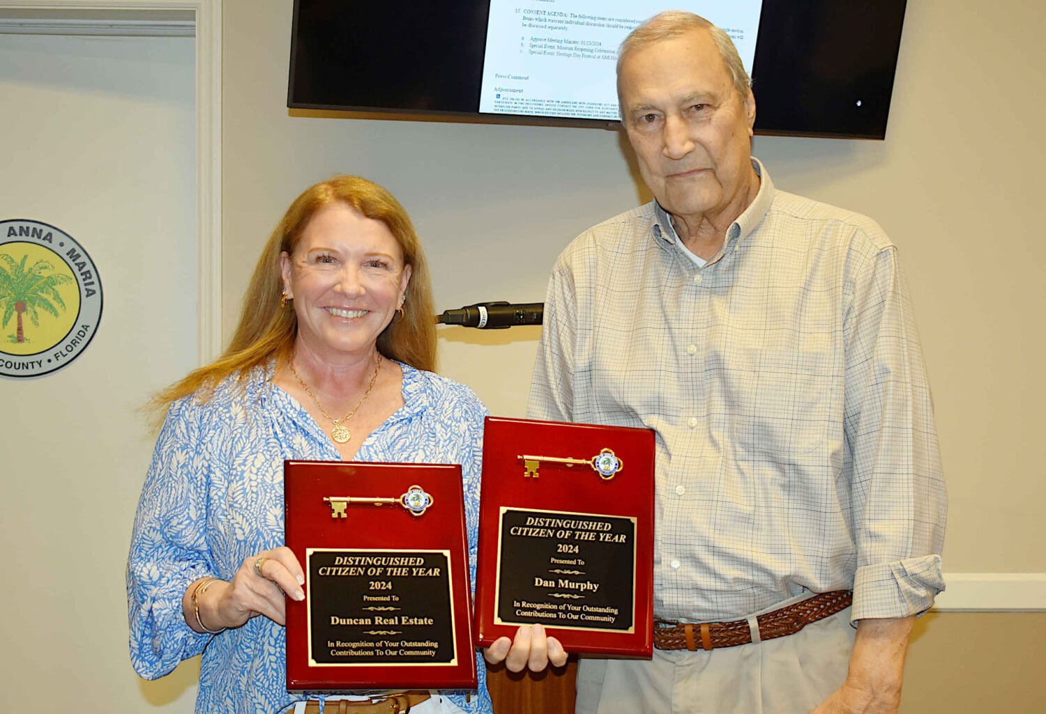 Murphy residents receive Citizens of the Year award from Duncan Real Estate officials.