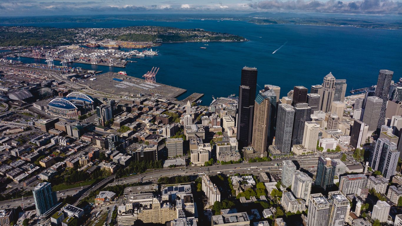 Seattle office building exterior with empty parking lot amidst return to work trend.