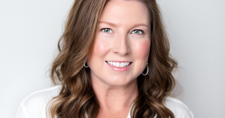 Erika Doyle, industry professional, smiling in a modern office setting.