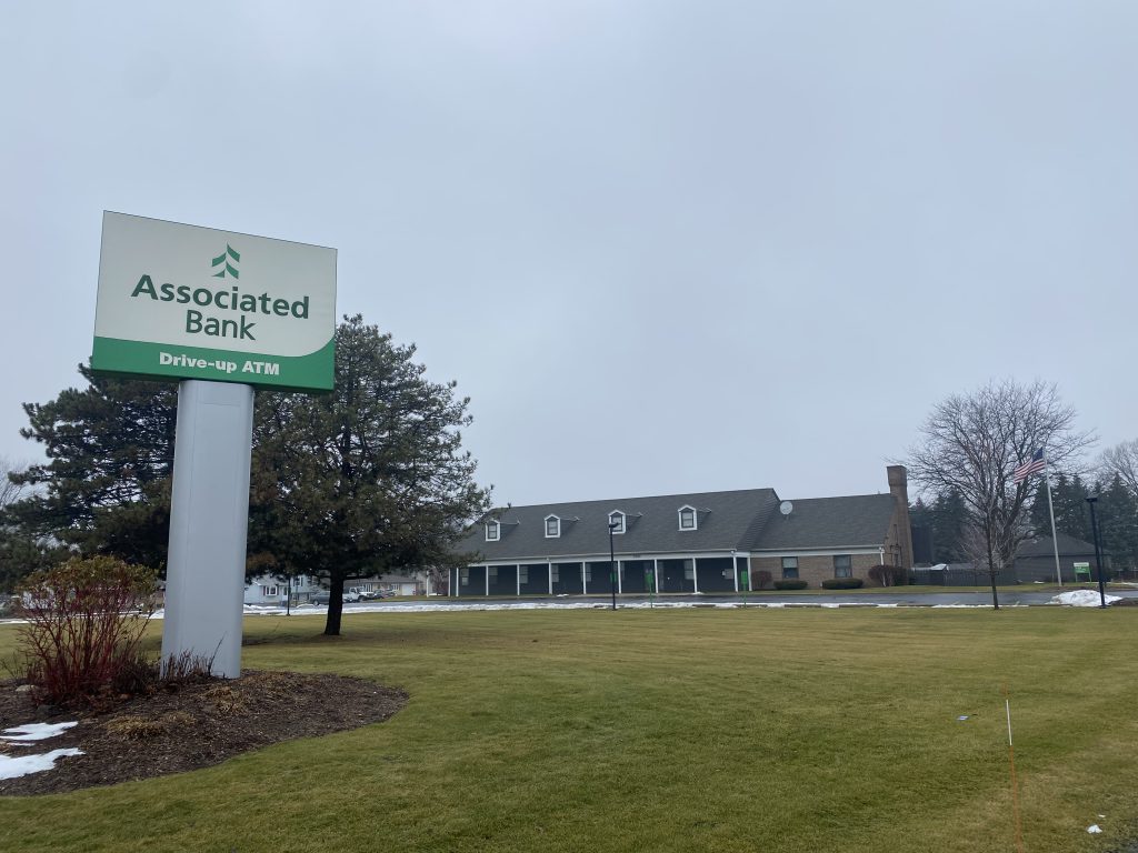 Associated Bank Slinger branch building exterior with new ownership signage installed.